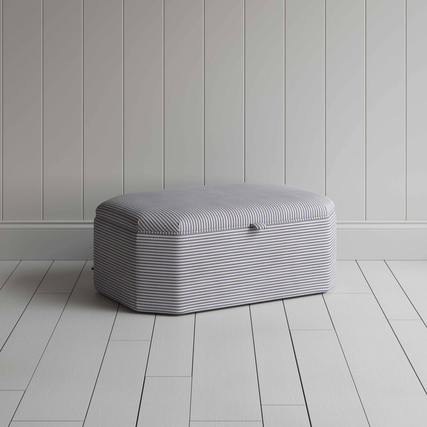 Stylish grey ottoman against white flooring.