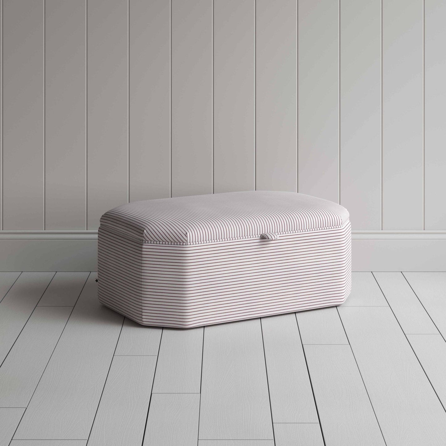 Stylish grey ottoman against white flooring.