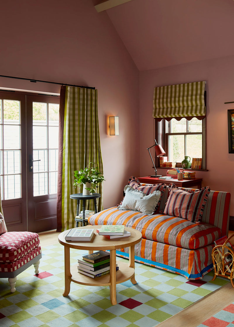 A cozy living room with a couch, table, and chair.