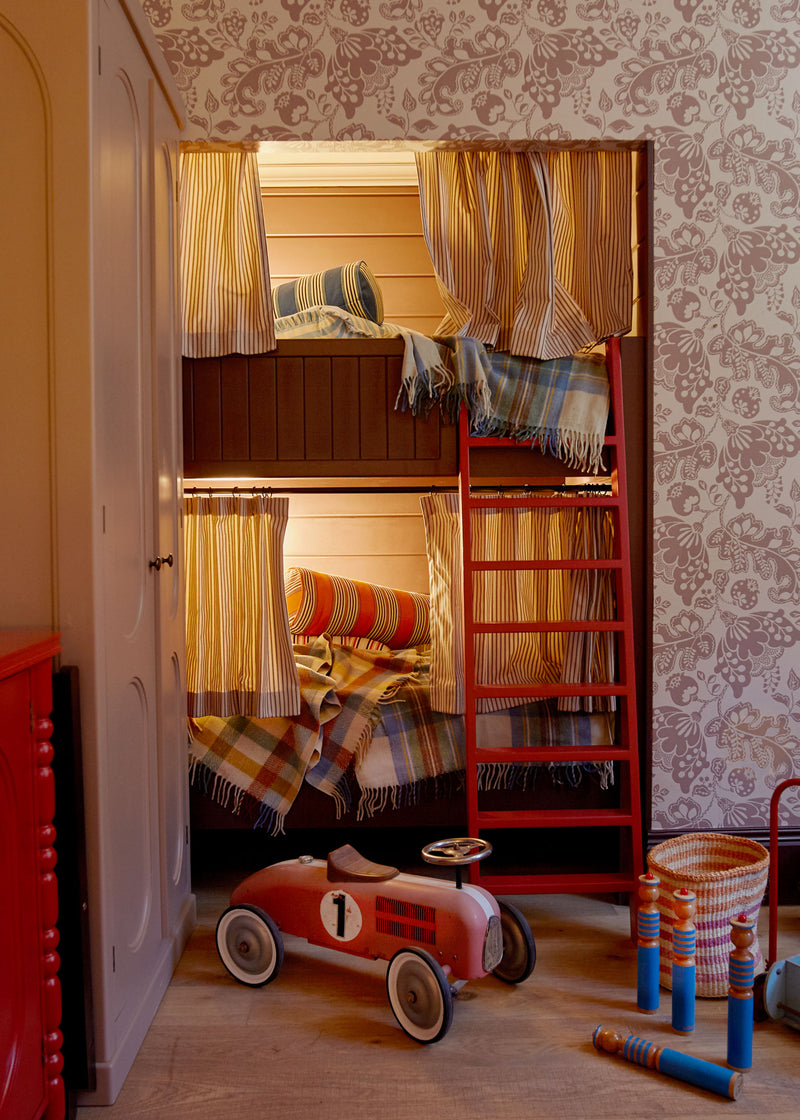 A room with a bunk bed and a toy car.