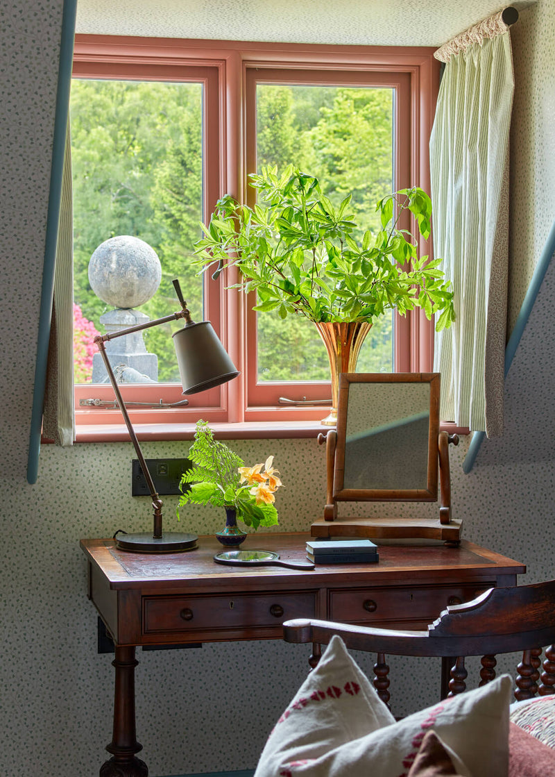 A well-lit desk with a lamp and a potted plant, creating a serene and productive workspace.