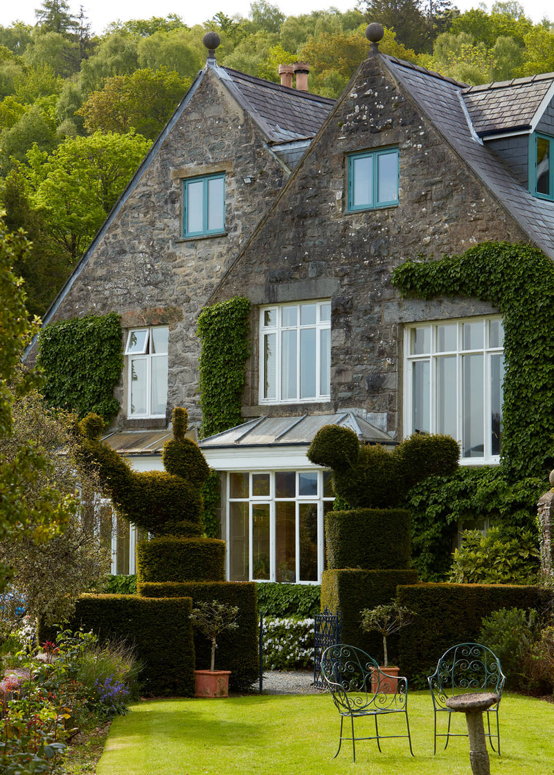 A picturesque stone house nestled amidst nature's beauty, exuding charm and elegance.