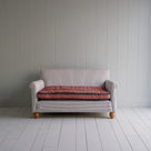  Front view of the 2-seater sofa in Ticking Cotton Chocolate Navy fabric with a Regatta Flame seat, framed by NiX 