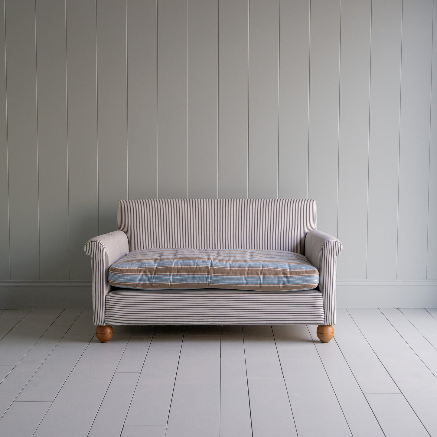 Front View of Idler 2 Seater Sofa in Ticking Cotton Chocolate Navy Frame and Regatta Blue Seat - By NiX