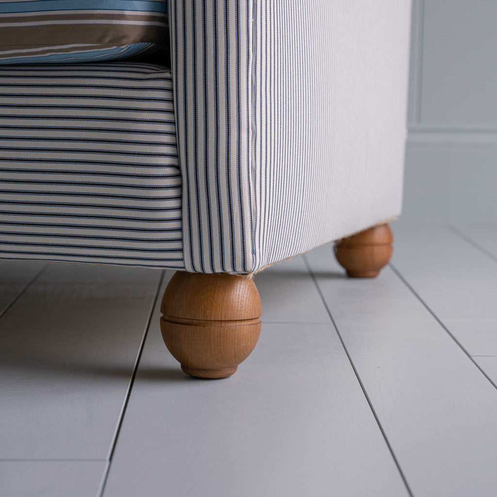  Round Wooden foot closeup of 2-seater sofa in Ticking Cotton Chocolate Navy frame with a Regatta Blue seat 