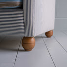  Round Wooden foot closeup of 2-seater sofa in Ticking Cotton Chocolate Navy frame with a Regatta Blue seat 