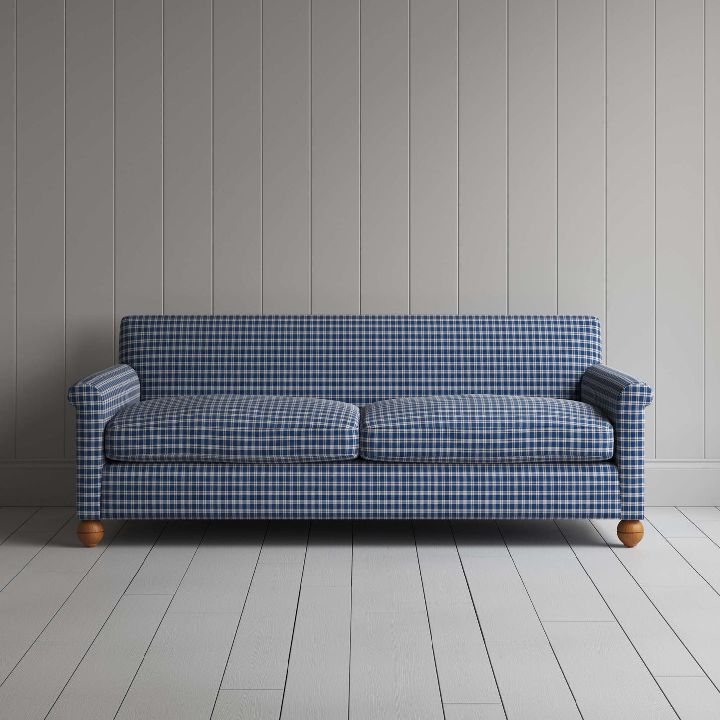 Blue and white sofa in checkered pattern by white wall.