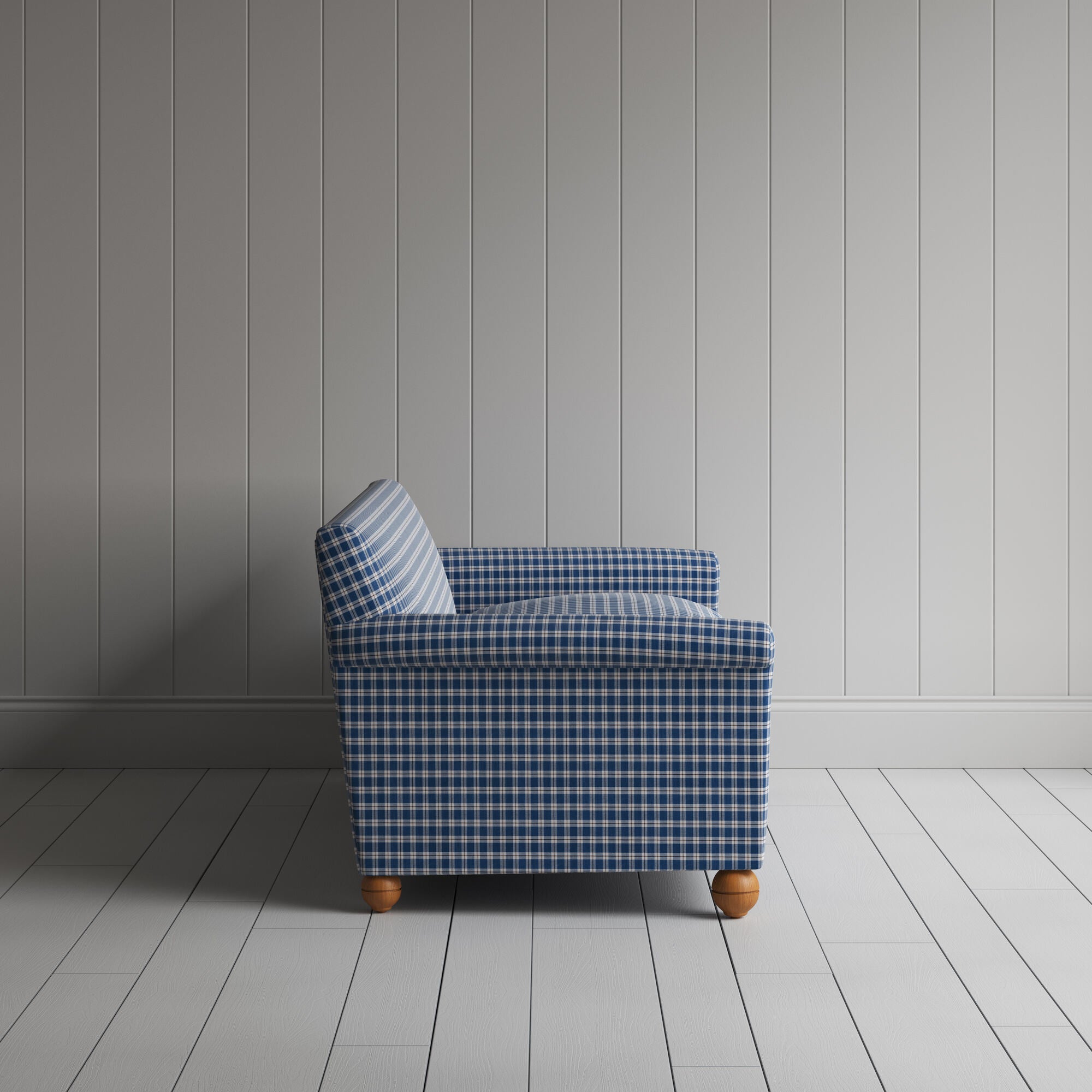  Blue and white checkered sofa against white wall. 