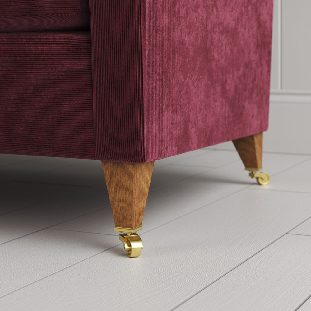  Idler 4 seater sofa close-up detail of tapered timber legs with castors by NiX. 