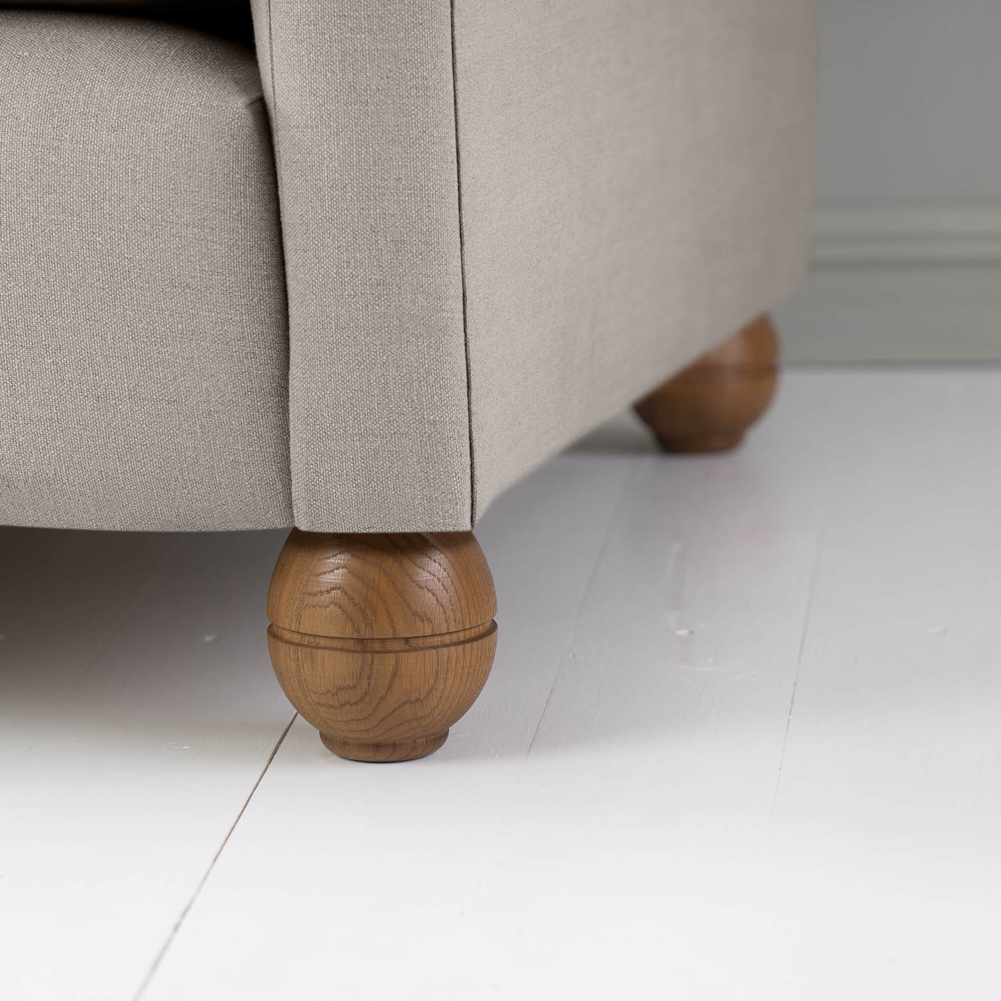 Round Wooden Foot Close up of Idler 3 Seater Sofa in Laidback Linen Pearl Grey - Manufactured By NiX (By Nicola Harding & Co) in London