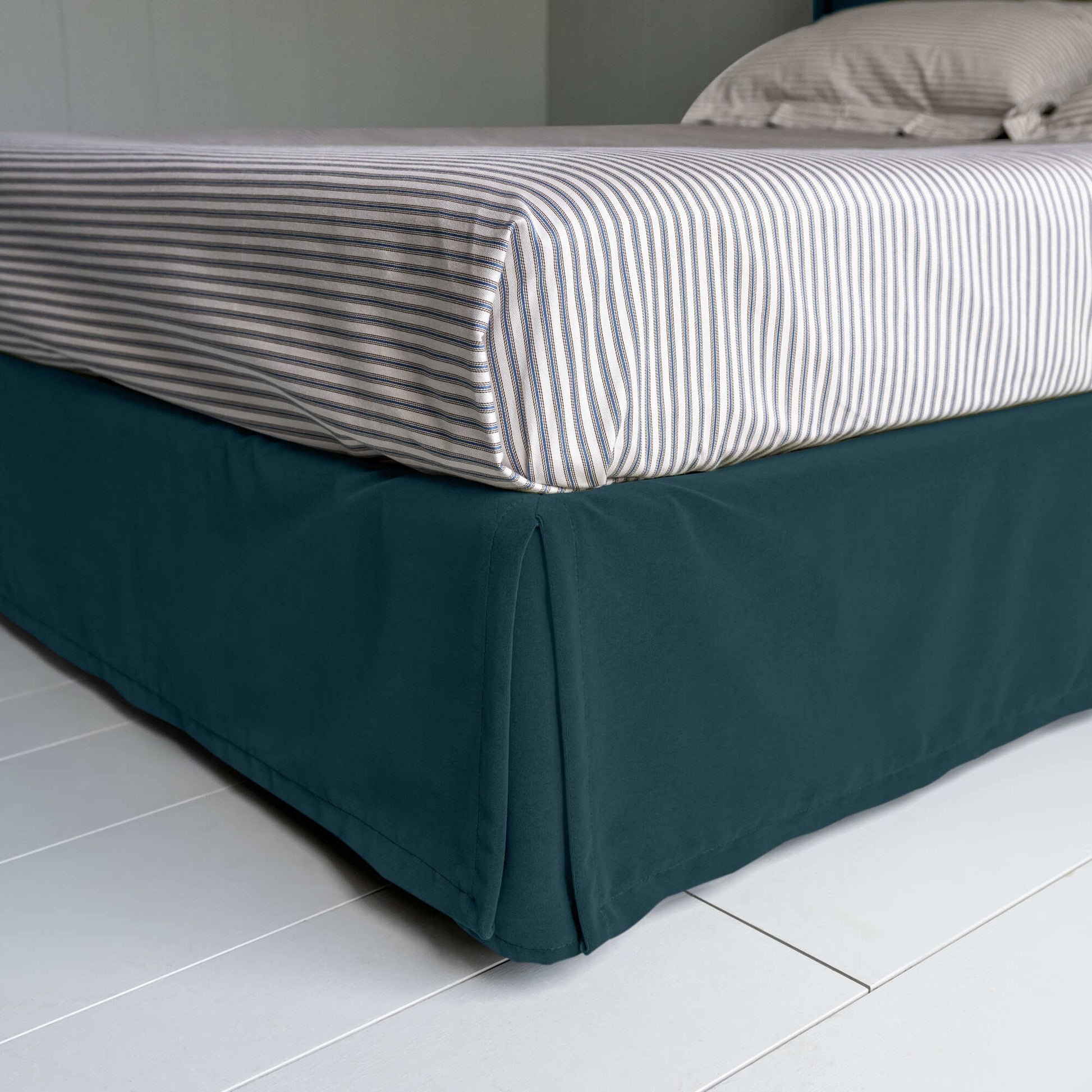 Seventh Heaven Upholstered Bed in Intelligent Velvet Aegean with Kick Pleat Valance, showcasing the edge design and a neatly tucked-in bedsheet.