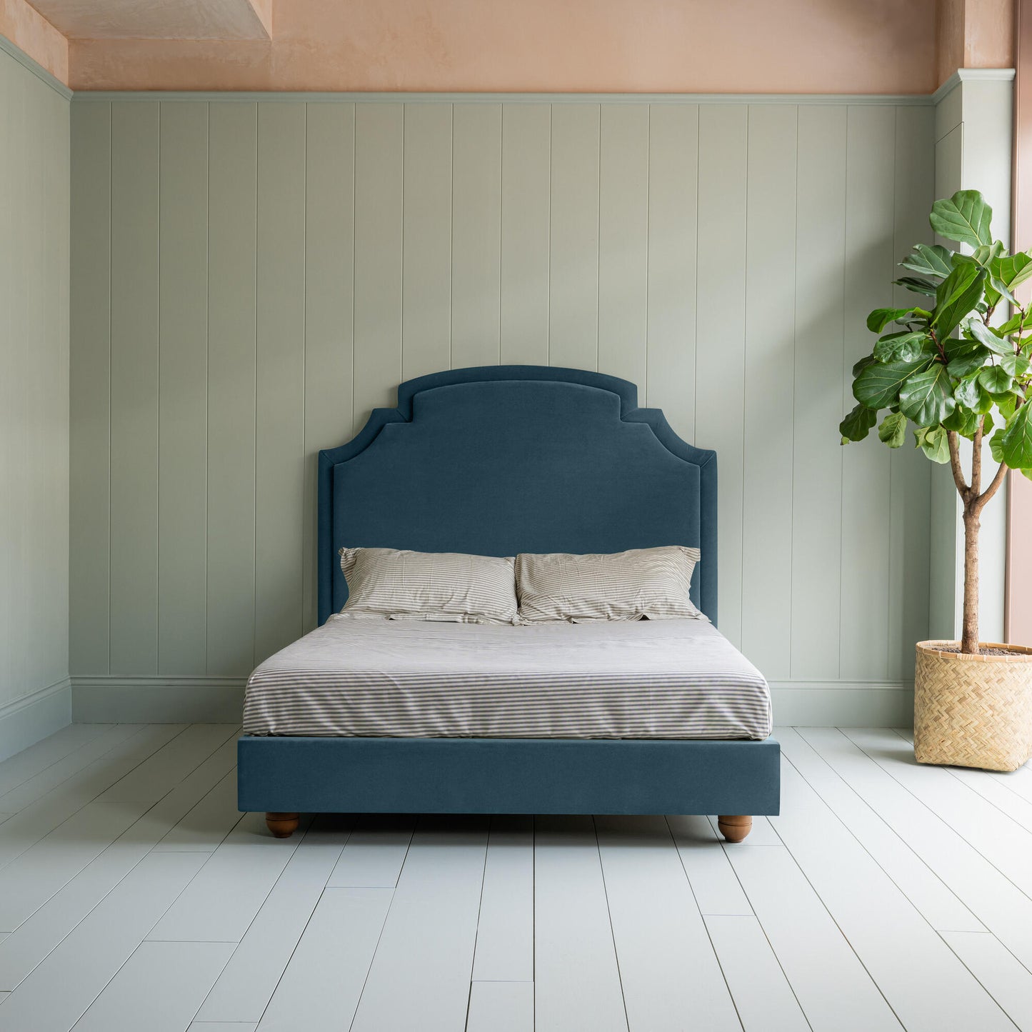 Seventh Heaven Upholstered Bed in Intelligent Velvet Aegean without Valance Front-view with a Indoor plant on the left.