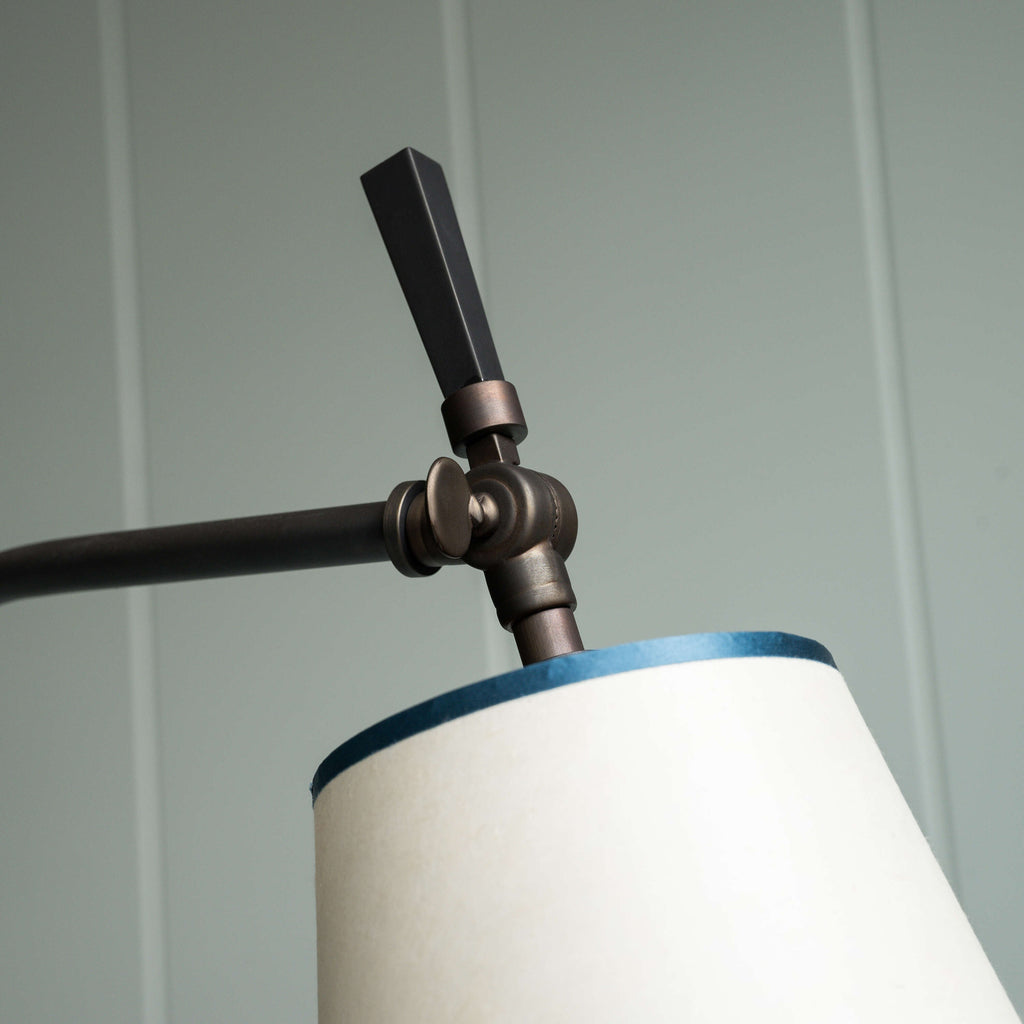  A lamp with a white shade and a black arm, providing stylish lighting for any room decor. 