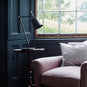  Focused Empire Lamp Shade in Waxed Brass with Rolled Edge, On a Side table Next to a NiX Armchair - Nicola Harding 