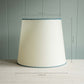 White lamp shade with blue trim, elegant design for modern decor.