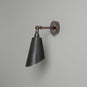  Black and bronze wall light with metal arm, perfect for modern decor. 
