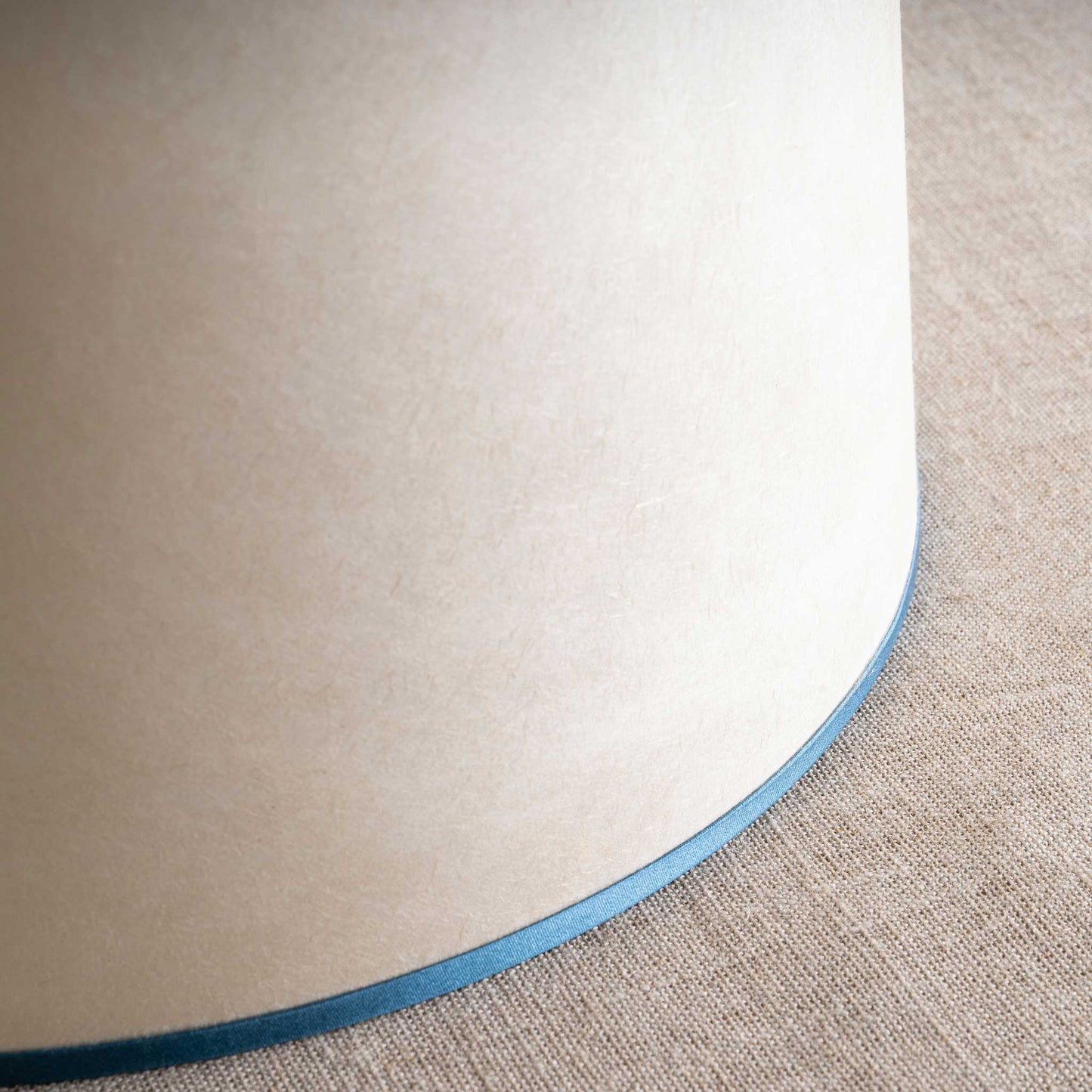 Close-up of a lamp on beige floor.