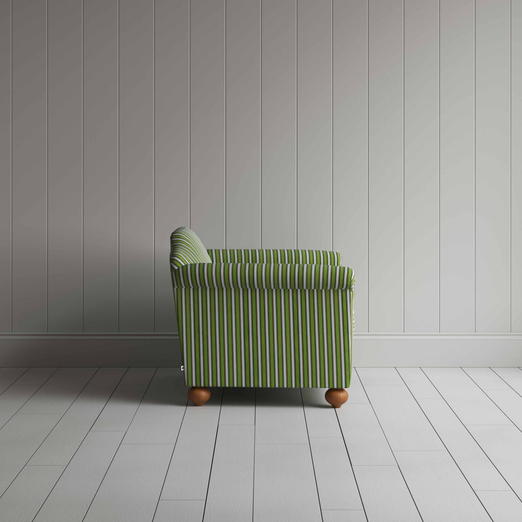  A white and green stripped sofa against the wall. 