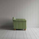  A white and green stripped sofa against the wall. 