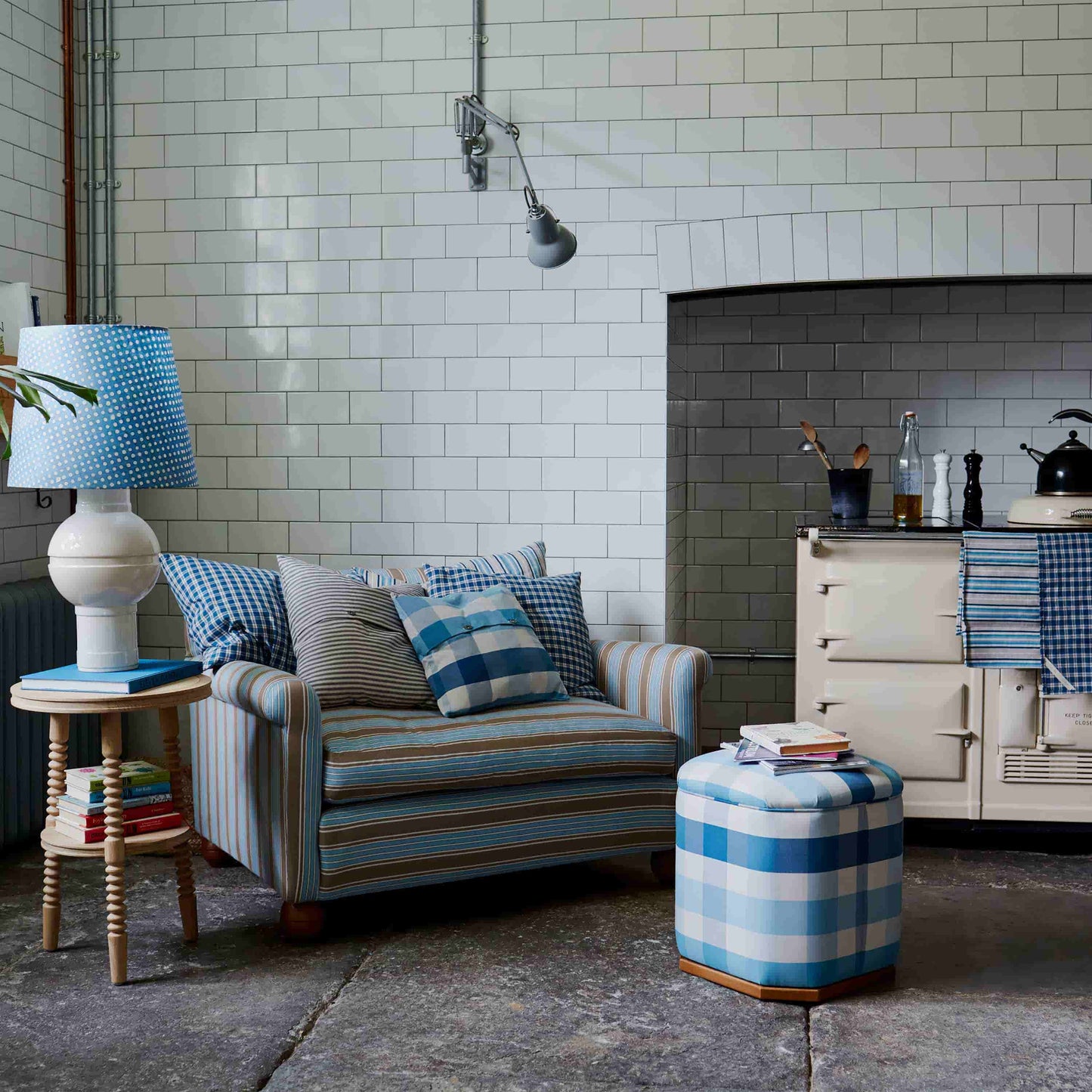 A cozy living room with a comfortable couch, a stylish lamp, a sleek table, and a decorative lampshade.