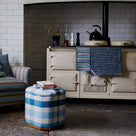  Tea towels on a stove oven, with an ottoman and love seat, designed by Nicola Harding & Co. 
