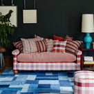  Stylish sofa designed by Nicola Harding & Co., elegantly paired with cushions in a beautifully arranged living room. 
