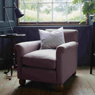  Armchair with Cushion Positioned Beside a Side Table Featuring a Table Lamp, Placed Next to a Window – NiX by Nicola Harding & Co. 