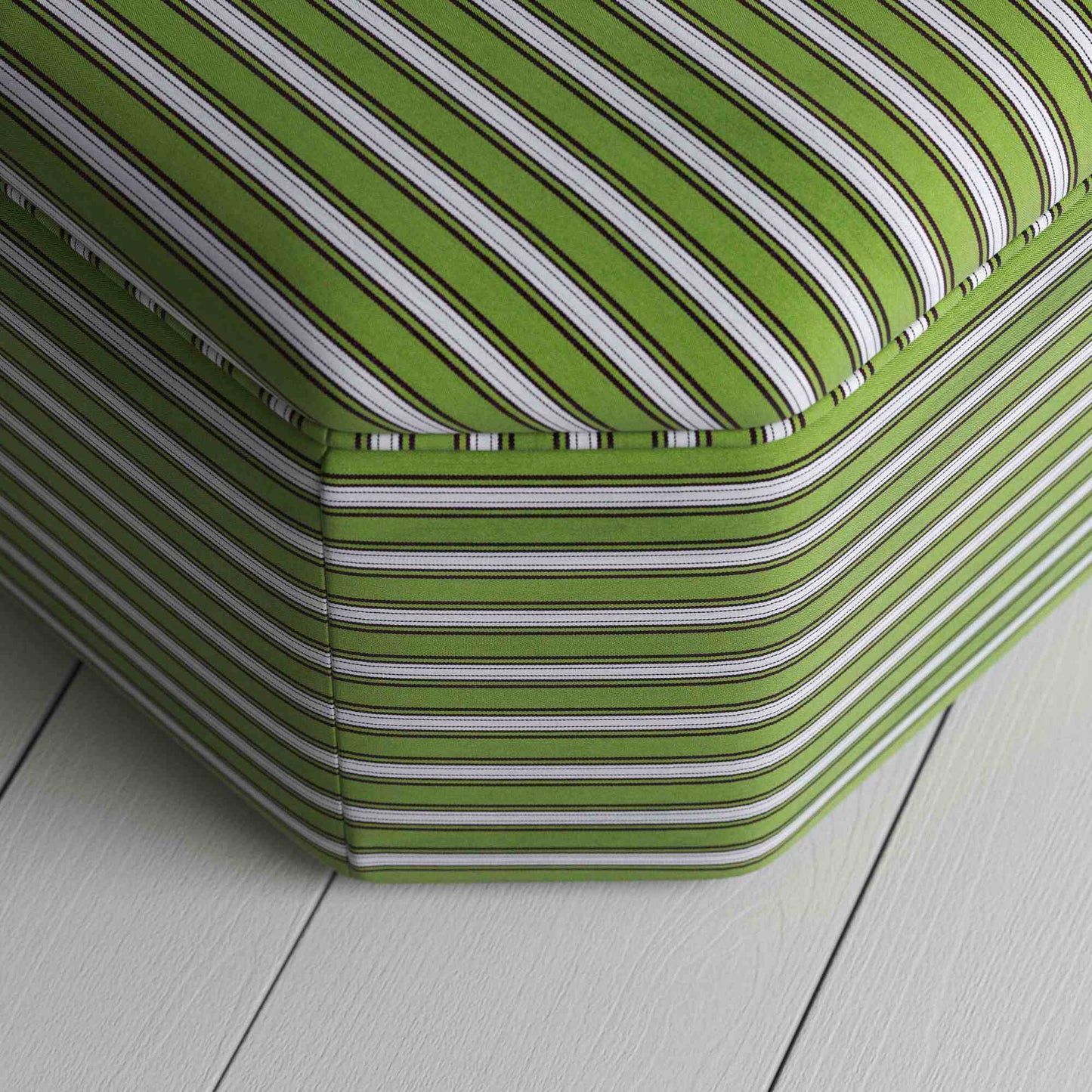 A close up of white and green stripped ottoman