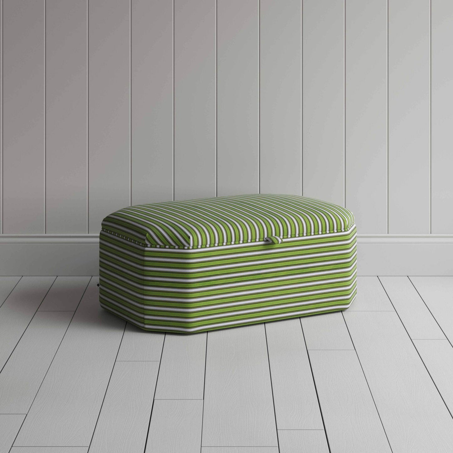 Ottoman with green and white stripes on wooden floor.