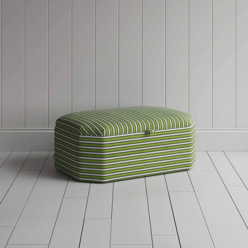  Ottoman with green and white stripes on wooden floor. 