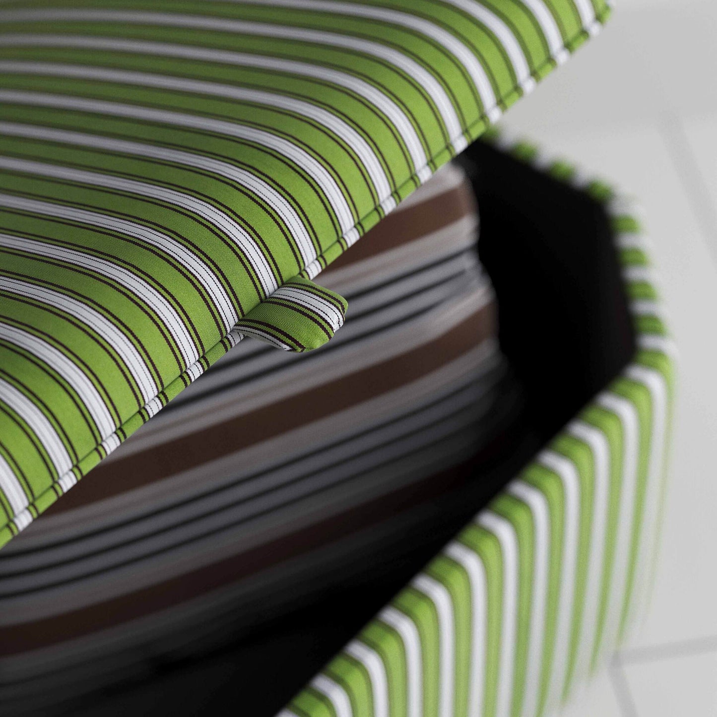 Fashionable ottoman with a green stripe, great for adding a pop of color to your room.