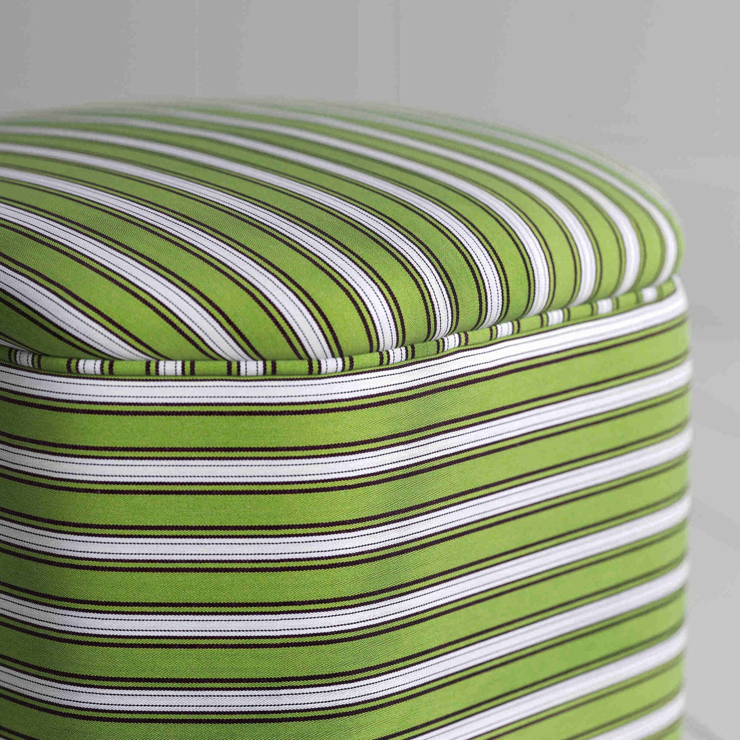 Green and white striped ottoman, perfect for adding a pop of color to any room decor.