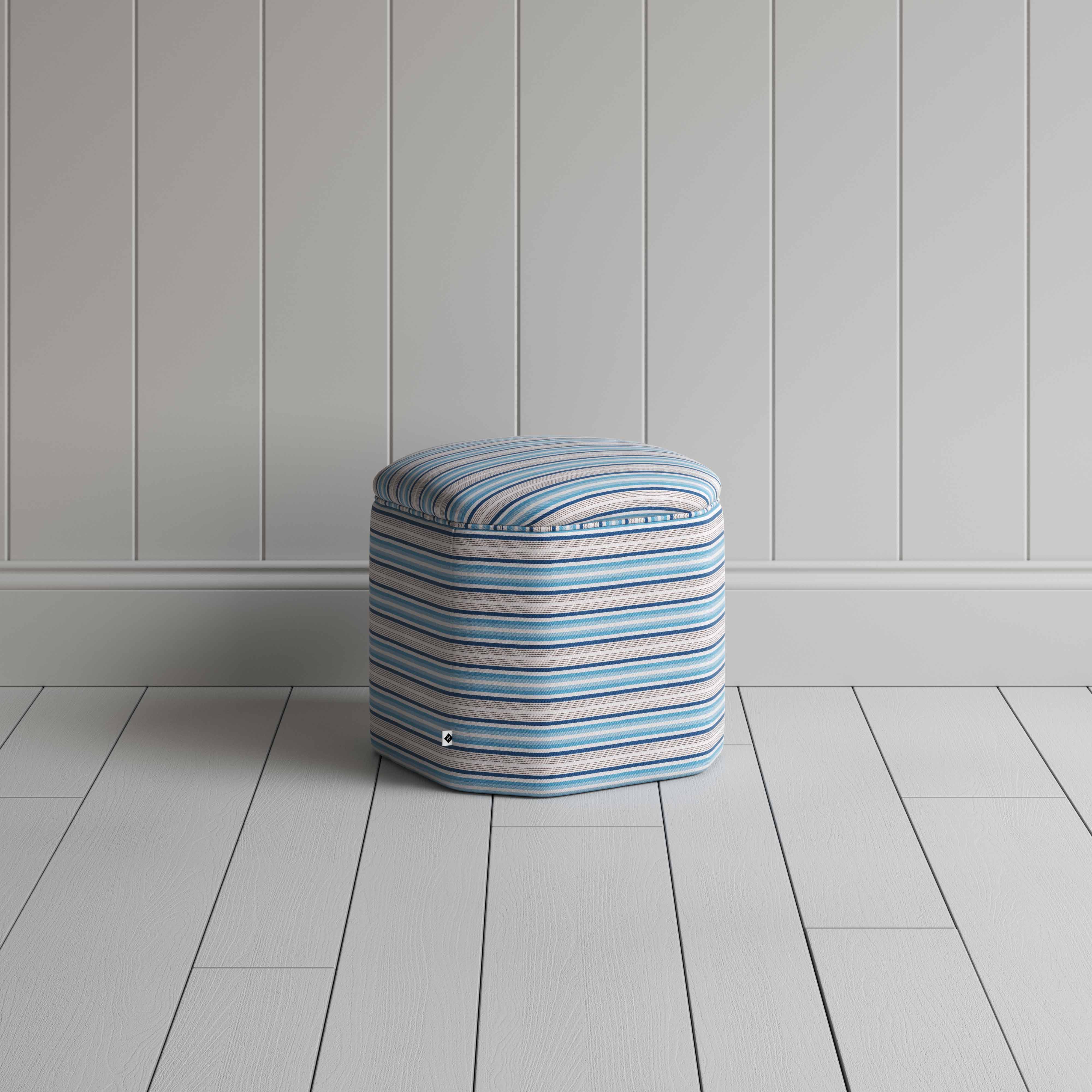  Small ottoman with blue and white stripes, ideal for a stylish and cozy seating option. 