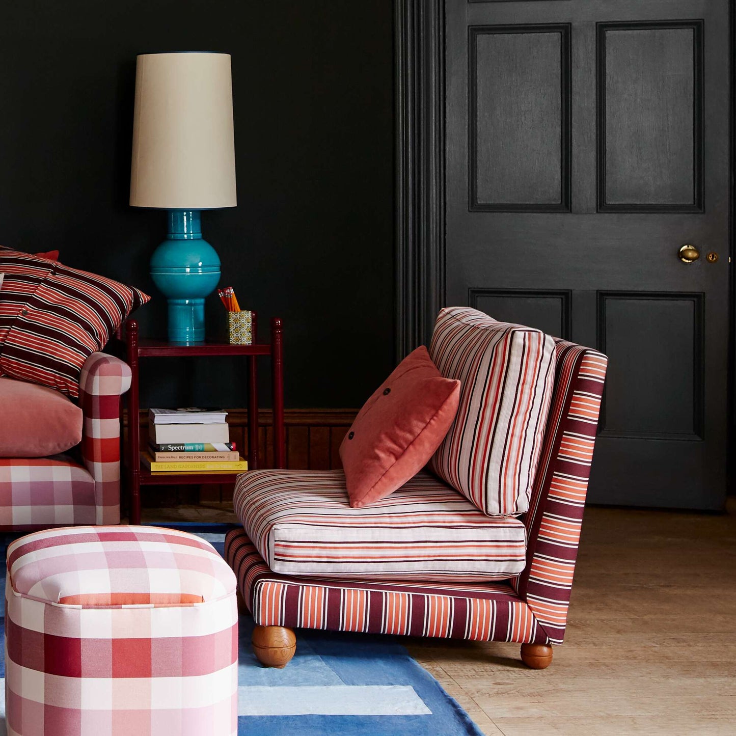 Slipper Chair With Cushions, ottomans, and a side table with a Blue base lamp in a living room - NiX