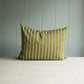 Striped pillow in green and white on table.