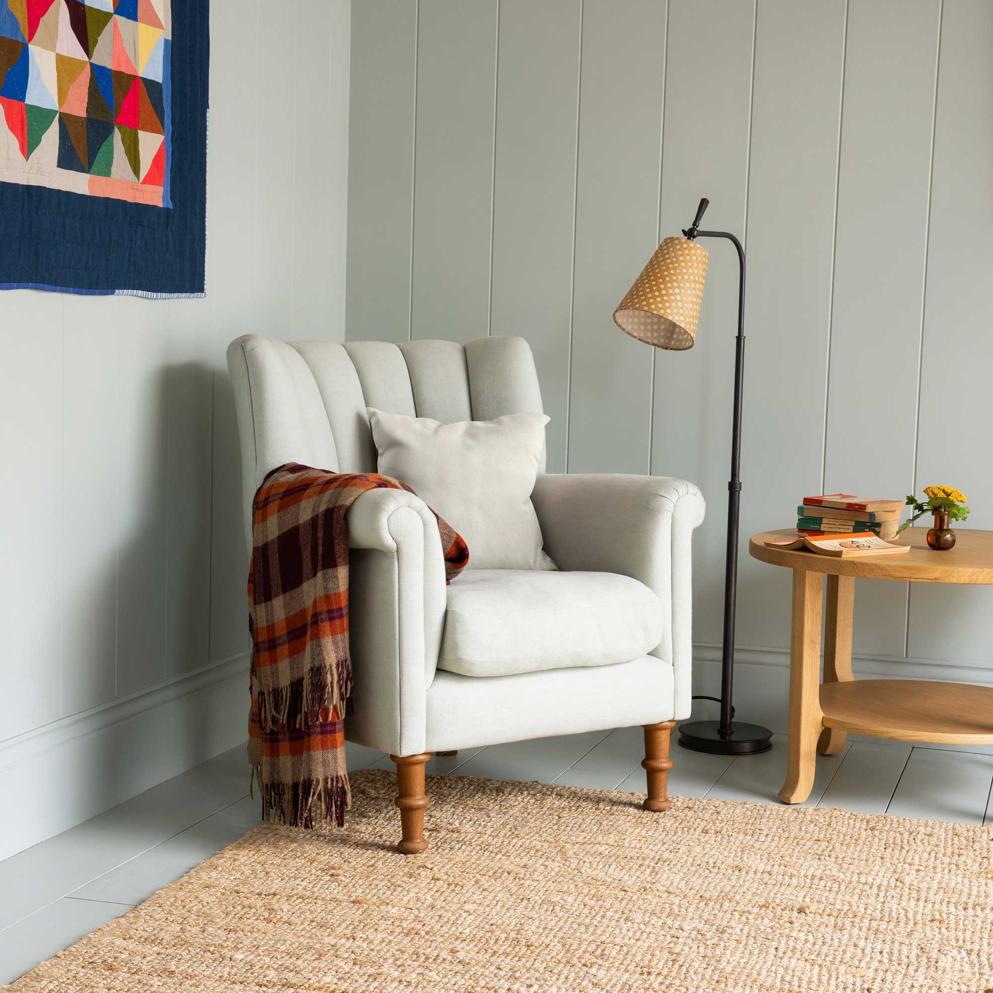 White Color Time Out Armchair in a Living Room Corner With Cushion, Sidetable, and Floor Brass Lamp - Nicola Harding & Co. 