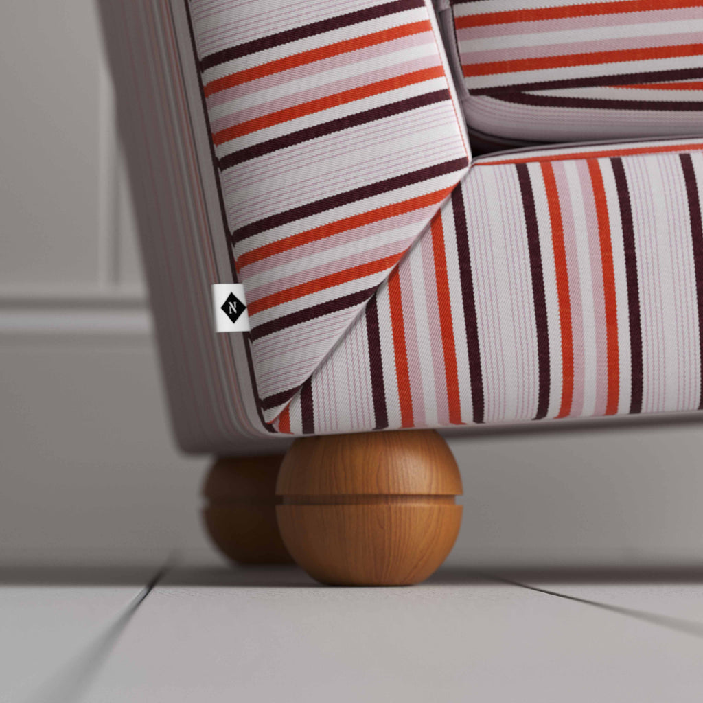  A close up of striped armchair with wooden legs on white floor. 