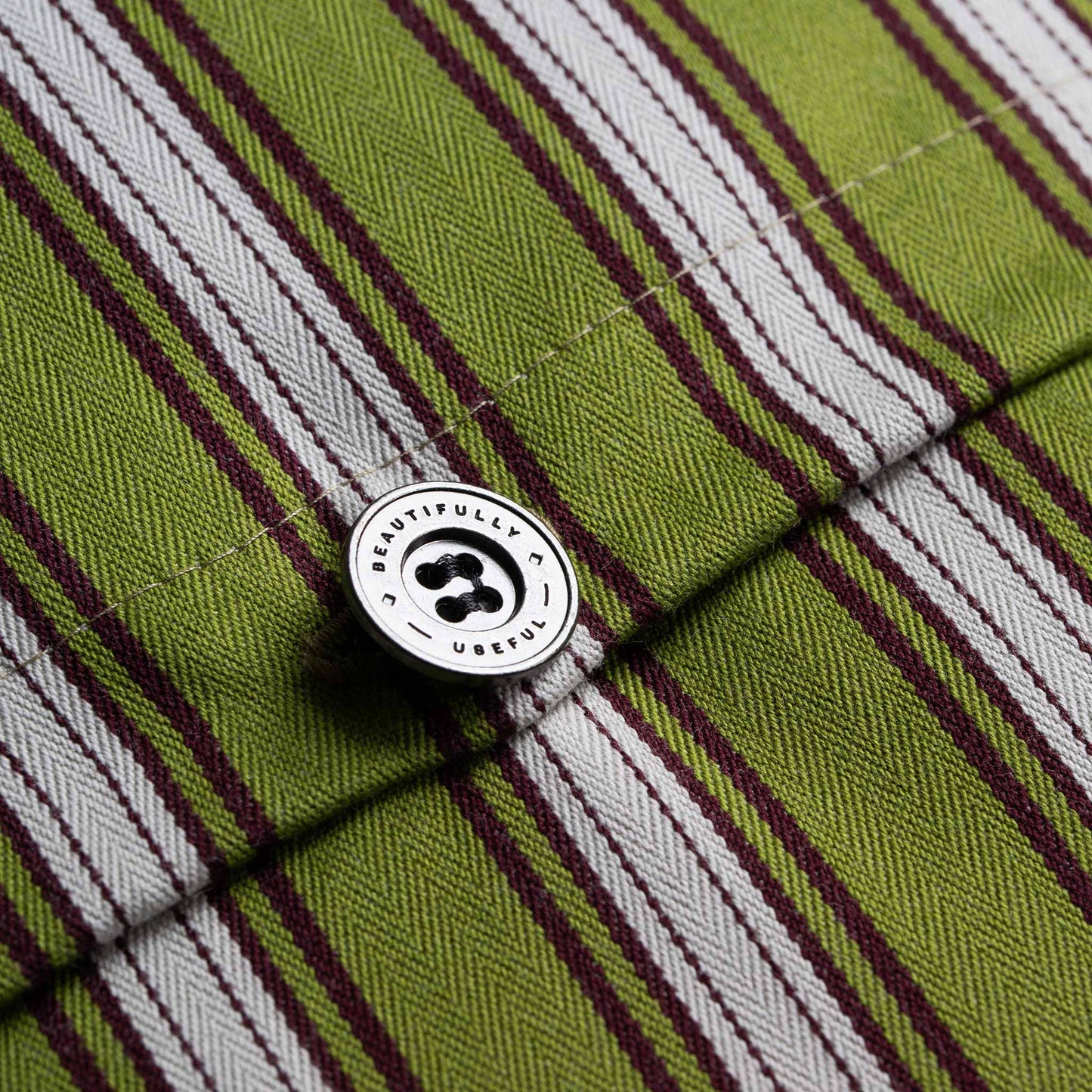 A fashionable green and white striped shirt up close with NiX Special Button.