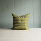 Showcasing a pillow with alternating green and white stripes.