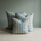 Three pillows featuring a blue and white plaid design.