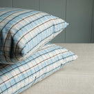  Pair of pillows featuring blue and white plaid design. 