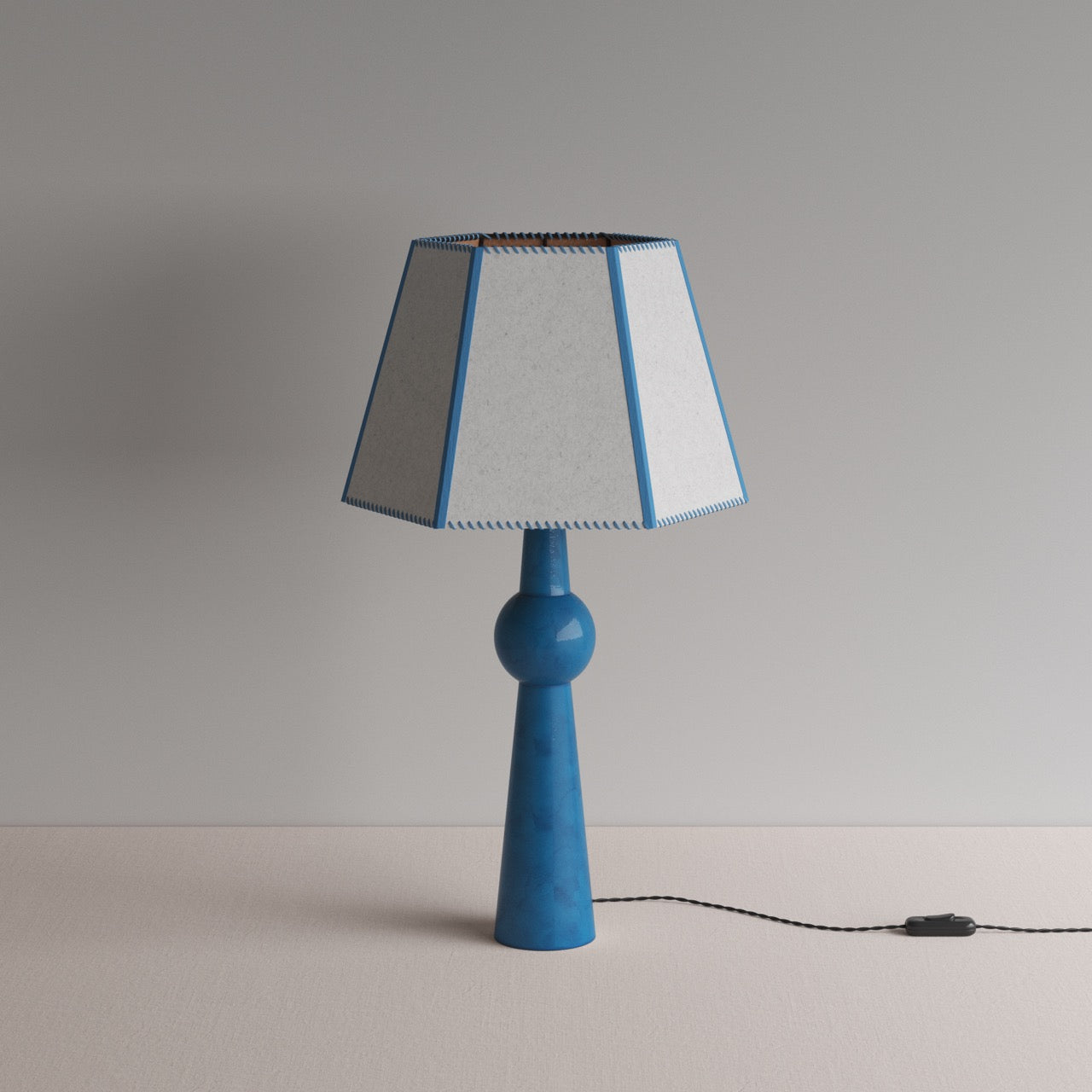 Comet Ceramic Table Lamp Base in Blue, With Townhouse Hexagonal Lamp Shade in Soft White with Peacock Blue Trim & Stitching - Nicola Harding