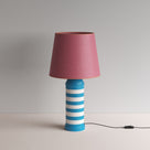  Humbug Striped Ceramic Table Lamp Base in Blue & Warm White, With Humbug Straight Empire Paper Lampshade in Burgundy Paper with Pink Trim - By NiX 