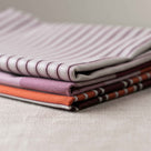  3 Tea Towels on top of each other including Towel in Ticking Organic Cotton, Berry - Nicola Harding 