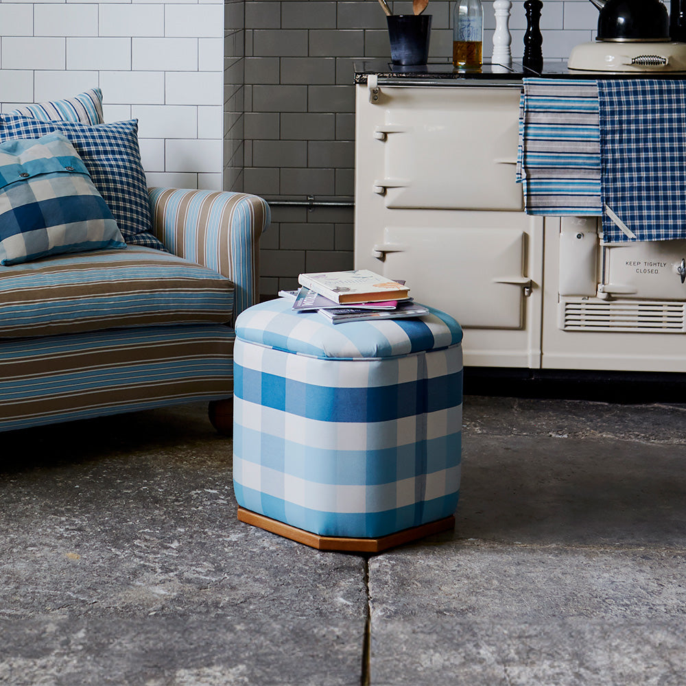  Stylish ottoman with books in front of loveseat with cushions - By NiX 