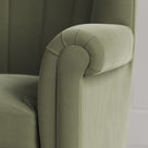 Time Out Armchair close-up detail of the rolled scroll arm and green tea velvet upholstery by NiX.