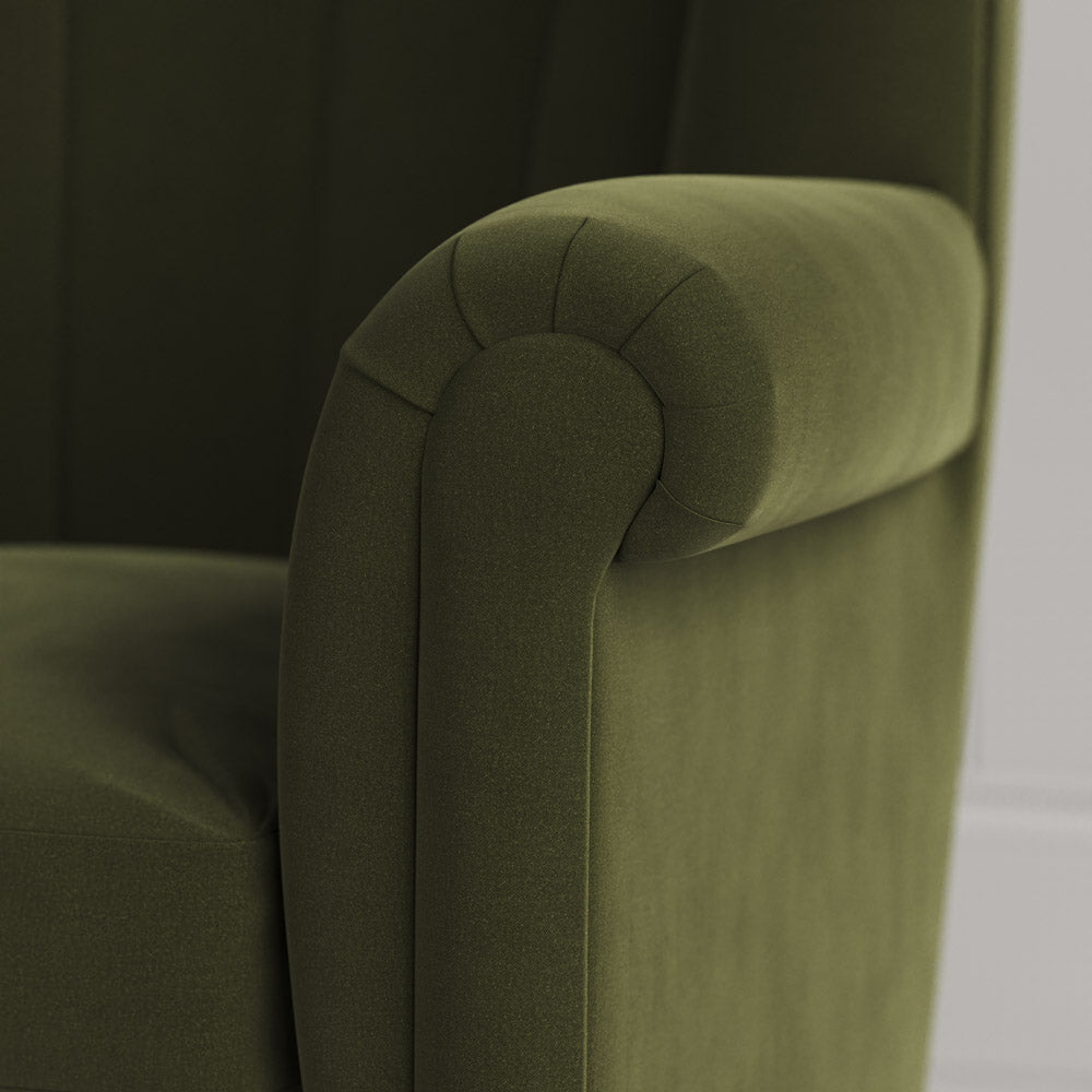 Time Out Armchair close-up detail of the rolled scroll arm and juniper velvet upholstery by NiX.