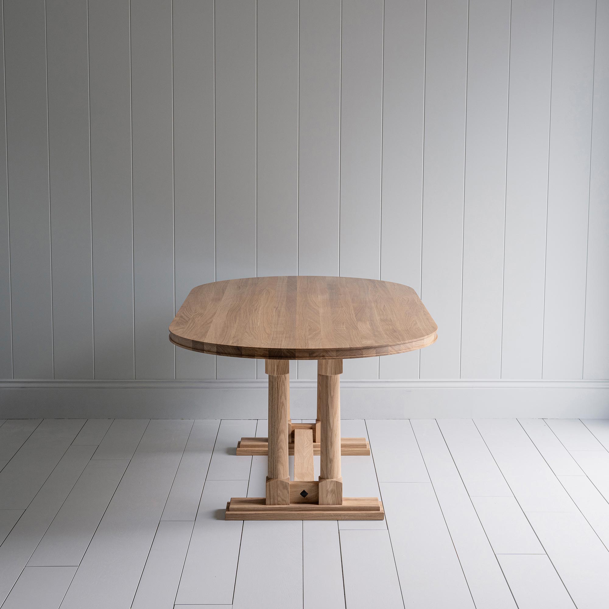  Side view of Tuck In Oval Dining Table in Oak by NiX 