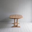  Side view of Tuck In Oval Dining Table in Oak by NiX 