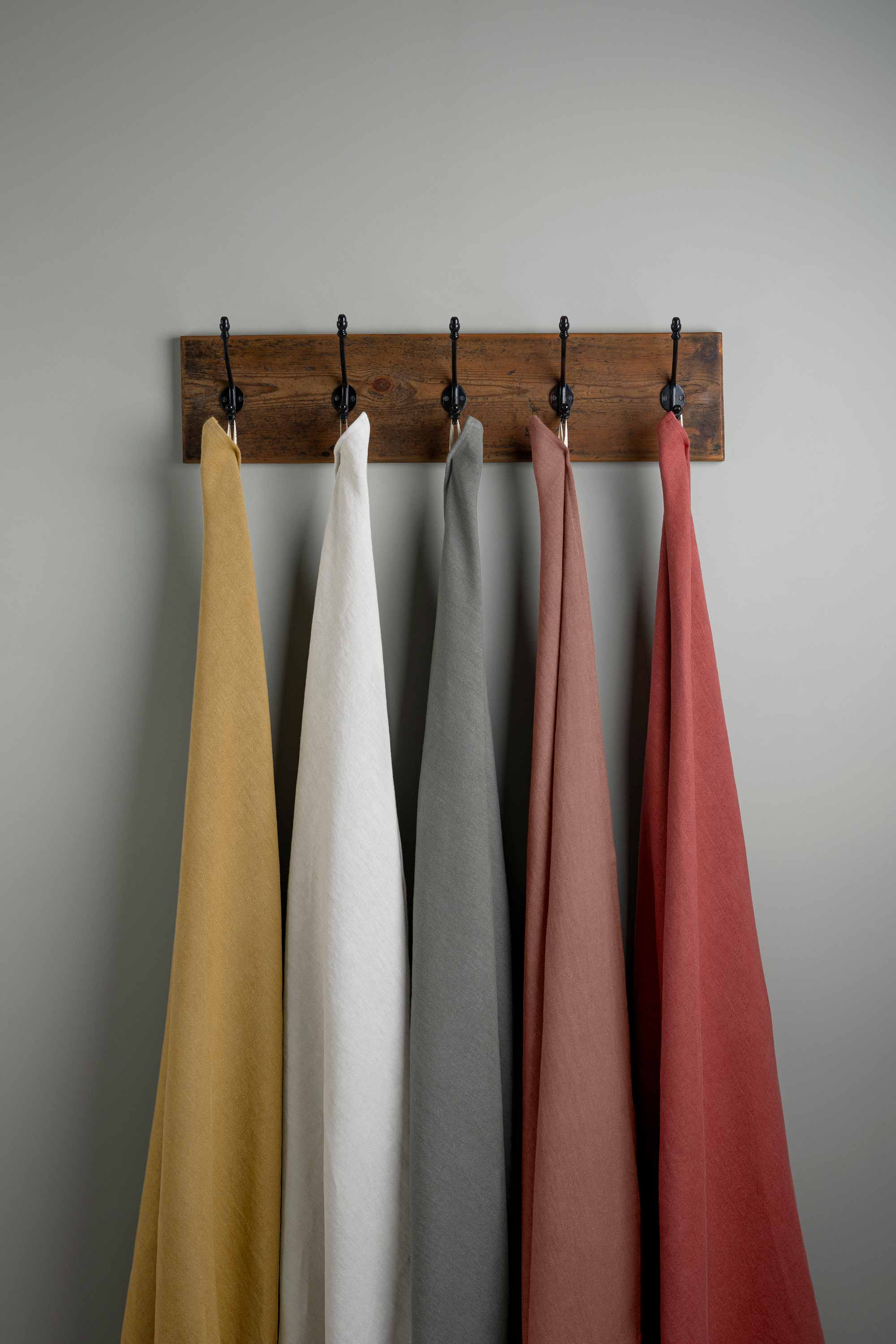  Linen Fabric Swatches in Different Colors Hanging on Hooks – By NiX 